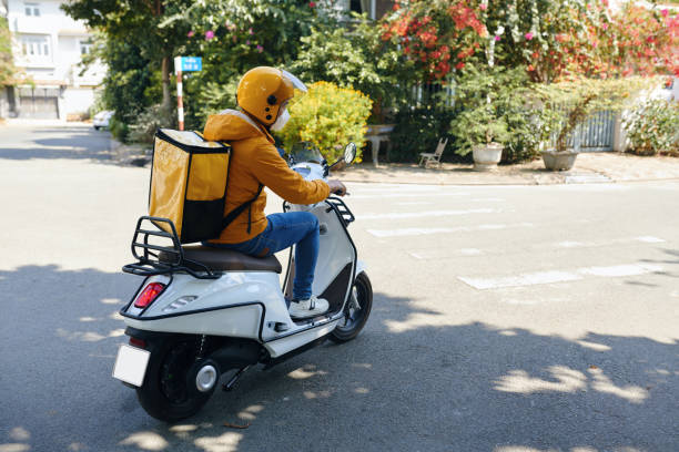 istock Delivery Man Riding Motorbike 2058257565
