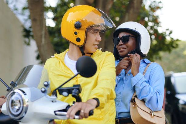 Passenger Buckling Helmet Passenger buckling helmet before ride on motorcycle taxi vietnamese man taxi motorbike driver stock pictures, royalty-free photos & images