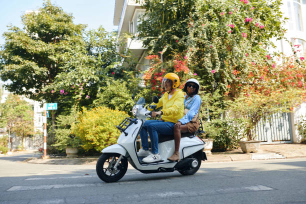 Woman Riding Motorbike Taxi Woman riding motorbike taxi to get around town vietnamese man taxi motorbike driver stock pictures, royalty-free photos & images