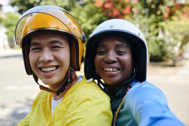 Happy Passenger and Motorbike Taxi Driver Happy passenger in helmet taking selfie with motorbike taxi driver vietnamese man taxi motorbike driver stock pictures, royalty-free photos & images