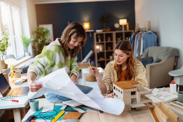 istock Two female architecture students making architectural model of a modern house 2058270508