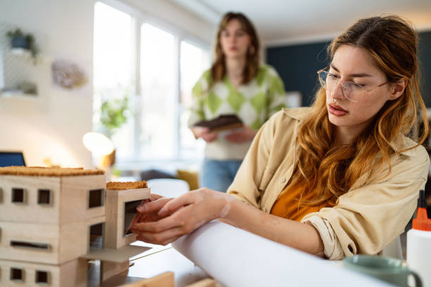 istock Female architecture student making architectural model of a modern house 2058272663