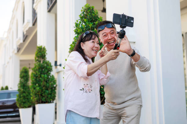 istock The elderly Asian couple happily video calls on their smartphone while exploring Georgetown, Penang. 2058275176