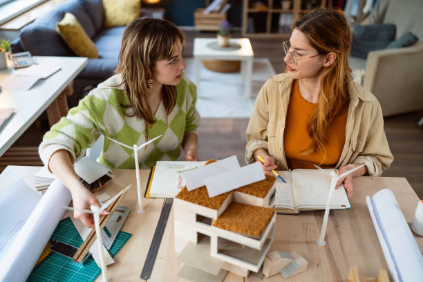 istock Two female architecture students making architectural model of a modern house 2058275833
