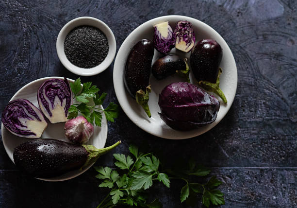 istock Purple vegetables arranged on a dark table 2058276902