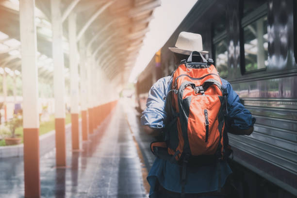 Traveler with backpack in train station. Travel concept.