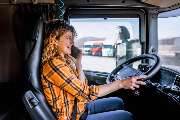 istock Female truck driver talking on mobile phone 2058284576