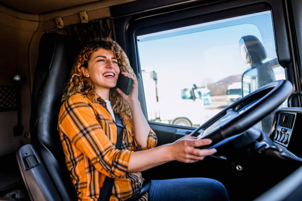 istock Female truck driver talking on mobile phone 2058284628