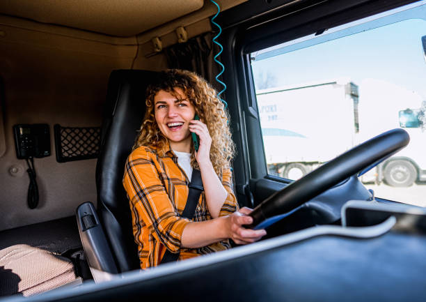 istock Female truck driver talking on mobile phone 2058285153