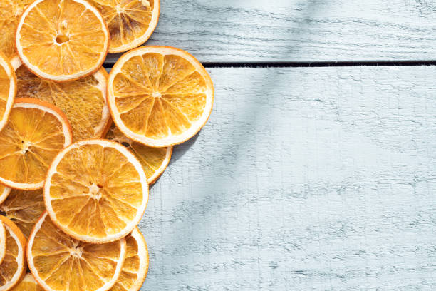 Dry orange slices on wood background