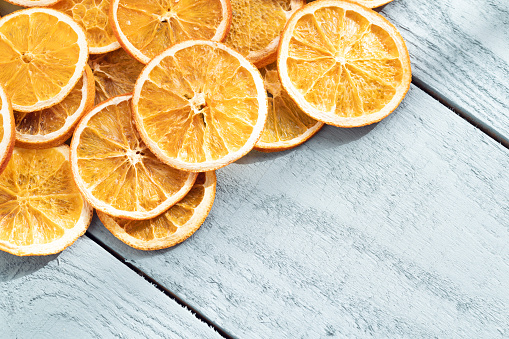 Dry orange slices on wood background