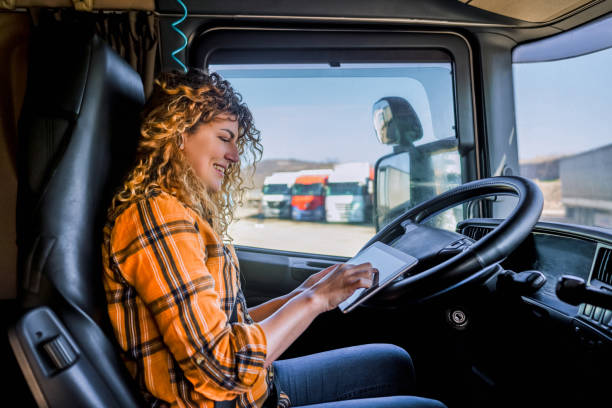 istock Female truck driver using a digital tablet 2058290502