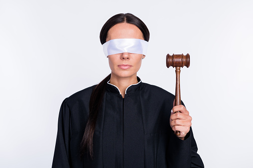 Photo of serious woman judge with closed eyes holding gavel wear black robe verdict isolated on white color background