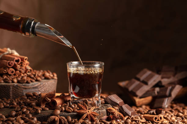 istock Coffee liquor is poured from a bottle into a glass. 2058311697