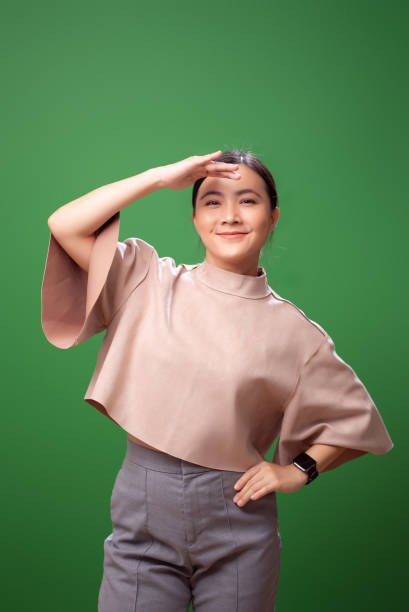 istock Asian woman making binoculars by hands and looking for searching or finding something. 2058319969