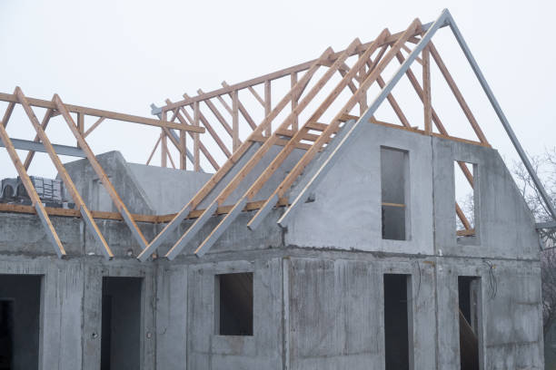 An ongoing construction site in the suburbs, featuring the framing stage of a single-family house.
