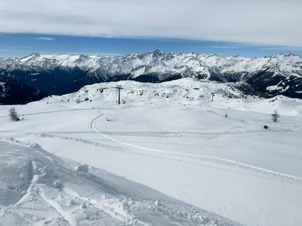 View of beautiful ski resort from skiing slope. Ski resort with glaciers in background.