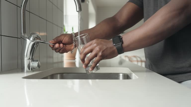 Man pouring up a glass of water