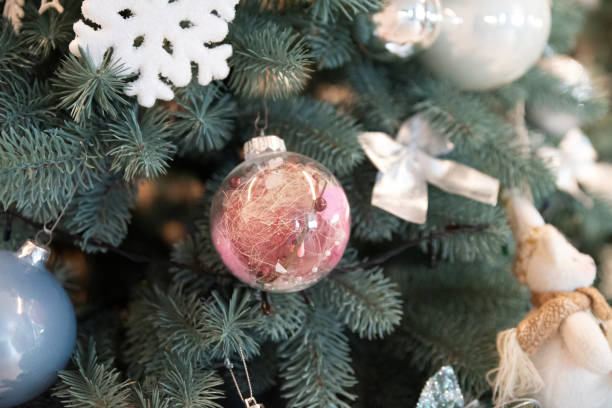 istock Transparent glass toy on a christmas tree close up 2058338987