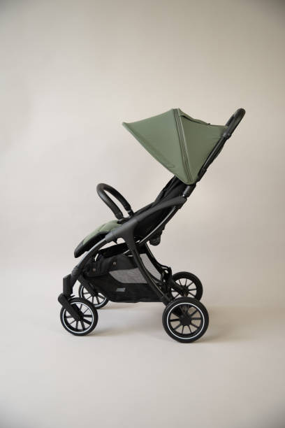 istock Green baby carriage on a light background 2058350274