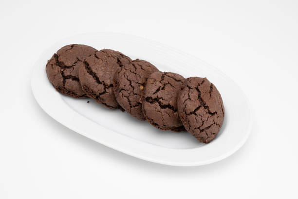 istock Cookies in porcelain plate on white background 2058352774