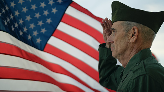 Veteran soldier senior old man against the American flag
