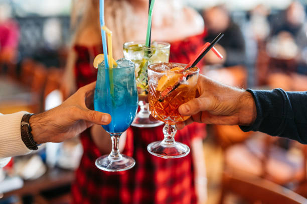 istock Three Young Friends Cheering With Cocktails In A Bar 2058359281