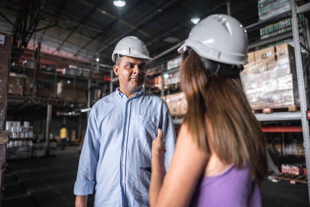 istock Coworkers talking at warehouse 2058369604