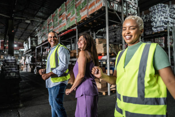 istock Coworkers dancing in a warehouse 2058373592