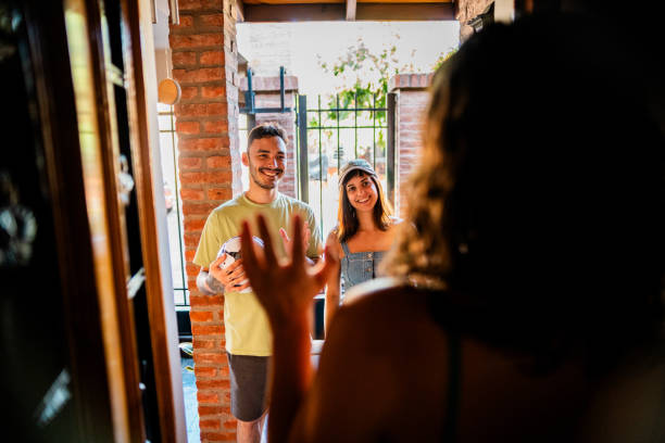 istock Young couple visiting friend at home 2058401733