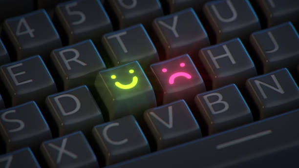 Happy and sad emoticons on the computer keyboard. The concept of mood swings. 3D render