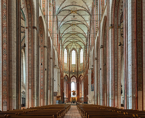 Lubeck, Germany - October 20, 2019: Interior of St. Mary's Church. The church was built between 1265 and 1352, destroyed by fire after air raid in 1942, and restored in 1947-1959. It has the tallest brick vault in the world, the height of the central nave is 38.5 metres (126 ft).