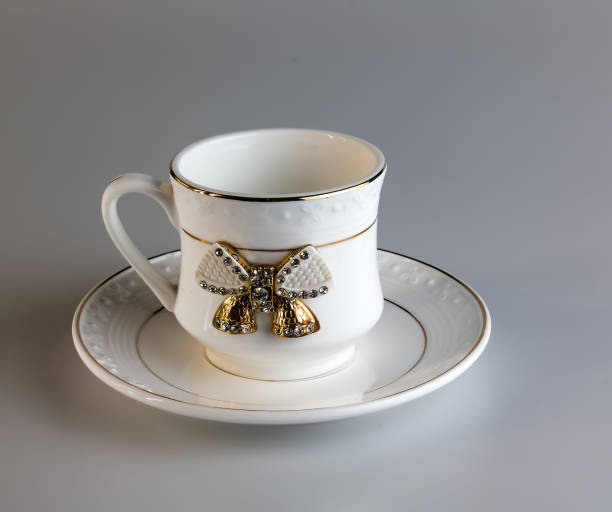 istock Empty antique porcelain coffee cup with bow on white background. 2058408178