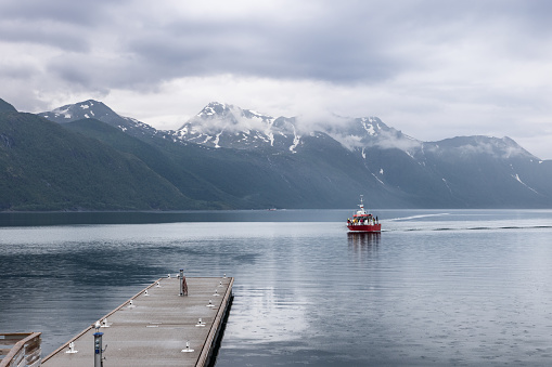 Svartisen - Norway. June 22, 2023: A tourist boat cruises towards the Svartisen Glacier, offering passengers a close encounter with Norway's majestic icy landscapes from a tranquil fjord