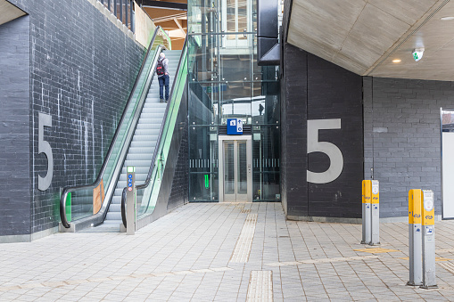Ede, The Netherlands - March 1, 2024: Passage with escalators to railway platforms at new Ede-Wageningen Central Station in The Netherlands