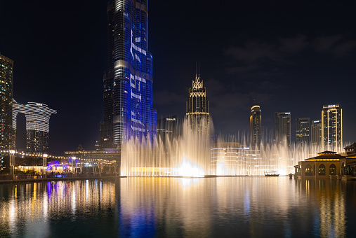 Dubai, United Arab Emirates - November 5, 2023: A picture of the Dubai Fountain light and water show at night.