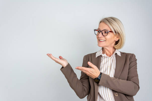 istock Blonde businesswoman pointing at copy space 2058511769
