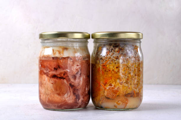 istock Canned pork and buckwheat in two glass jars 2058548344