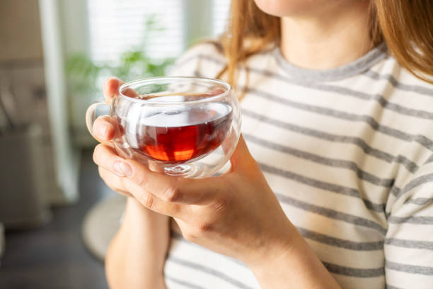 Woman holding a cup of tea.