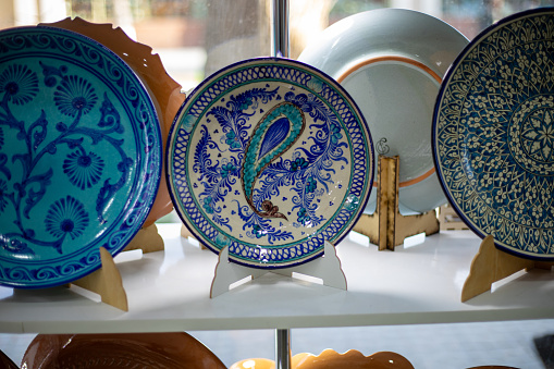 Uzbekistan, a traditional Uzbek plates in a display, handicraft items, passing from generation to generation, old crafting.
