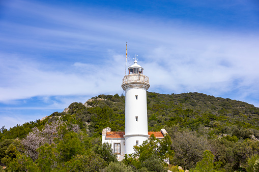 Lighthouse on the territory of the ancient fortress of Antirio on the coast of the Gulf of Corinth opposite the city of Patras.