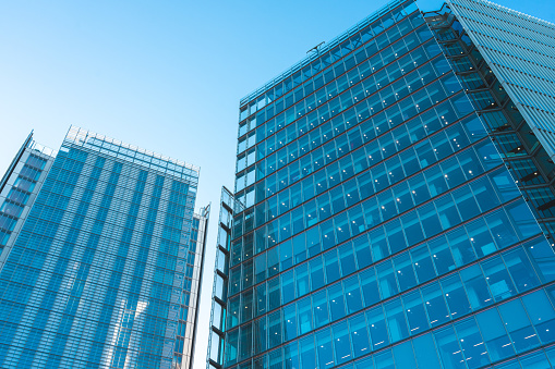 Looking directly up at the skyline of the financial district in central London