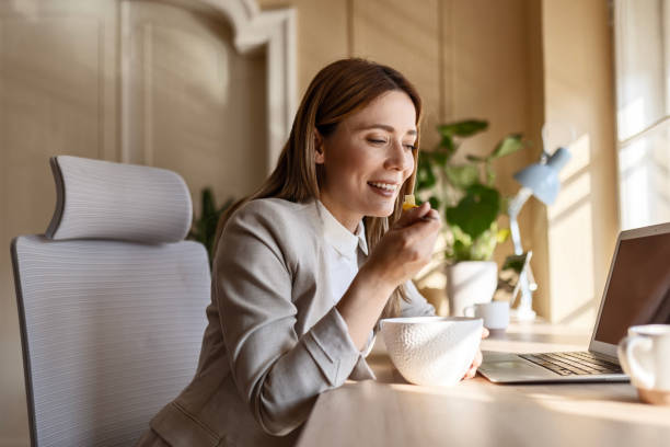 istock Happy Businesswoman's Nutritious Desk Meal 2058609231