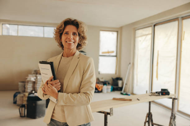 istock Female homeowner holding a renovation agreement for an interior kitchen remodel 2058618416