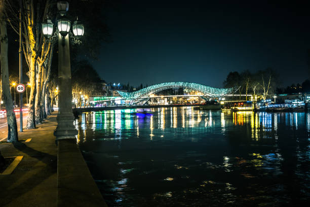 Evening view of River Mtkvari and illuminated Bridge of piece , Tbilisi, Georgia