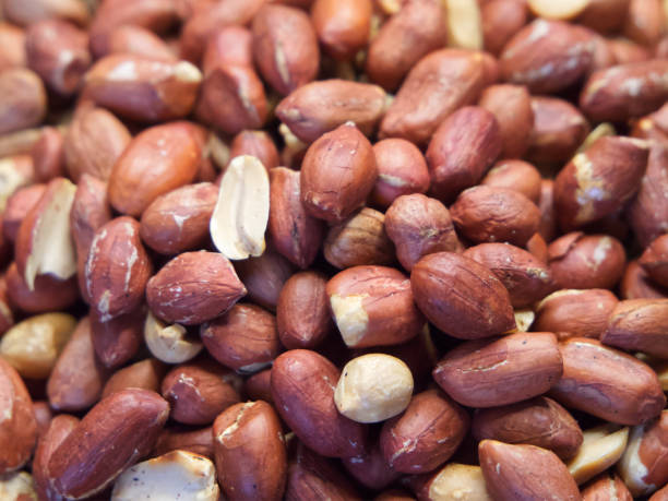 istock Roasted unpeeled peanuts macro, peanuts as a background. Groundnut Texture 2058637841