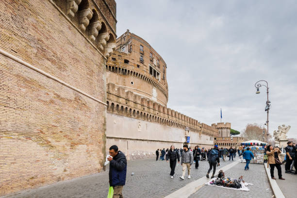 Rome, Italy - December 29, 2023: view of Saint Angelo Castle visited by tourists in the historic city center on a winter day