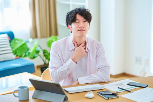 istock A young man feels discomfort in his throat 2058651188