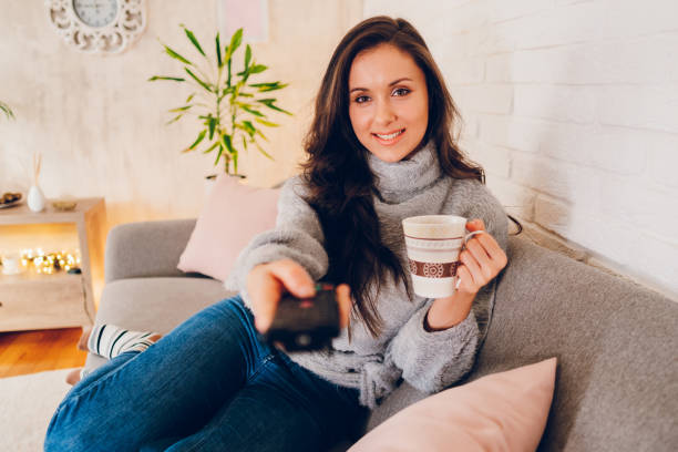 istock Woman watching tv at home 2058660063