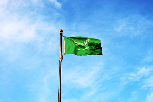 Saudi Arabia national flag waving in the sky. Islamic religion flag.
